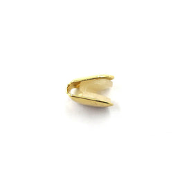 Gold-tone single tooth grill in a narrow side profile