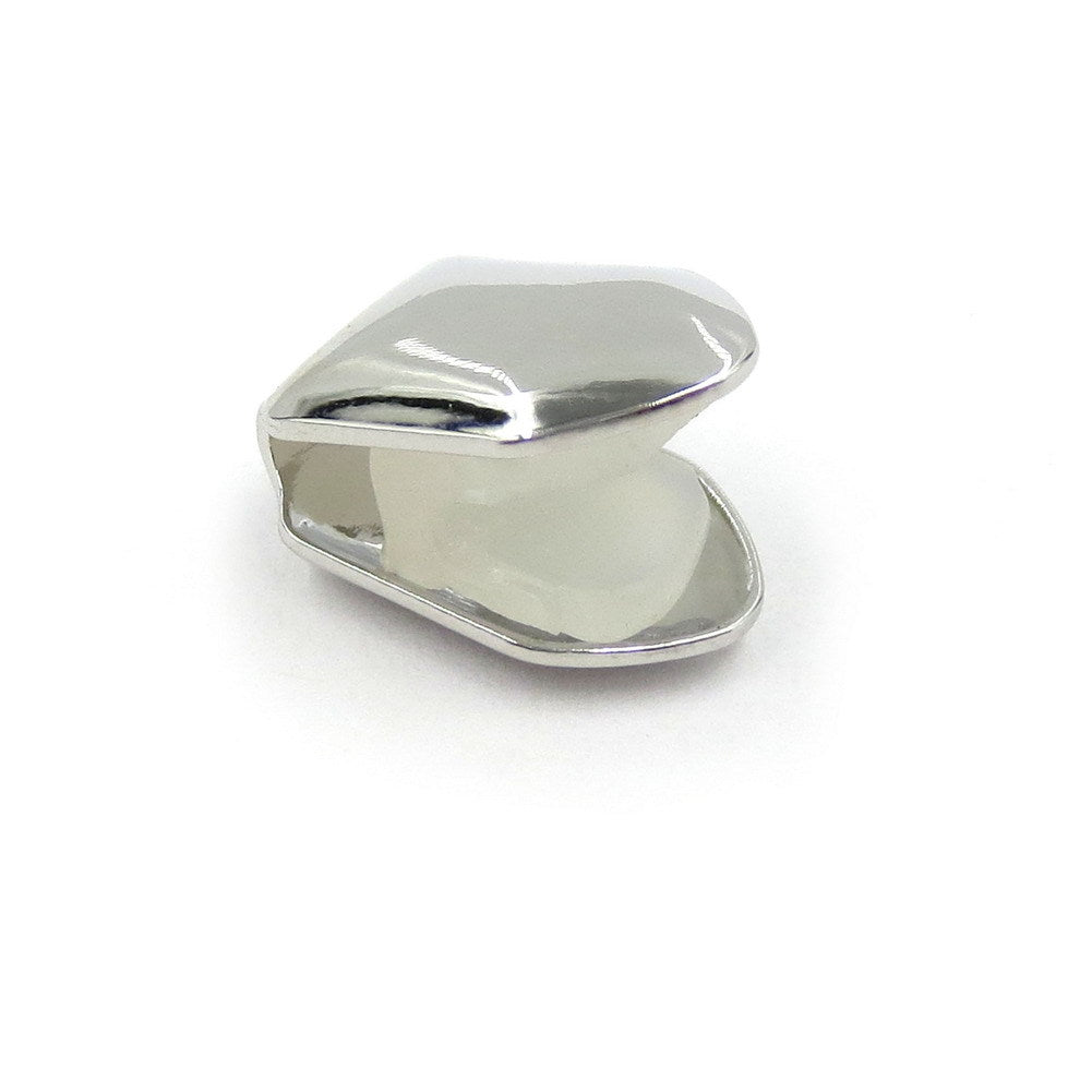 Silver-tone single tooth grill showing the curved inside and open back