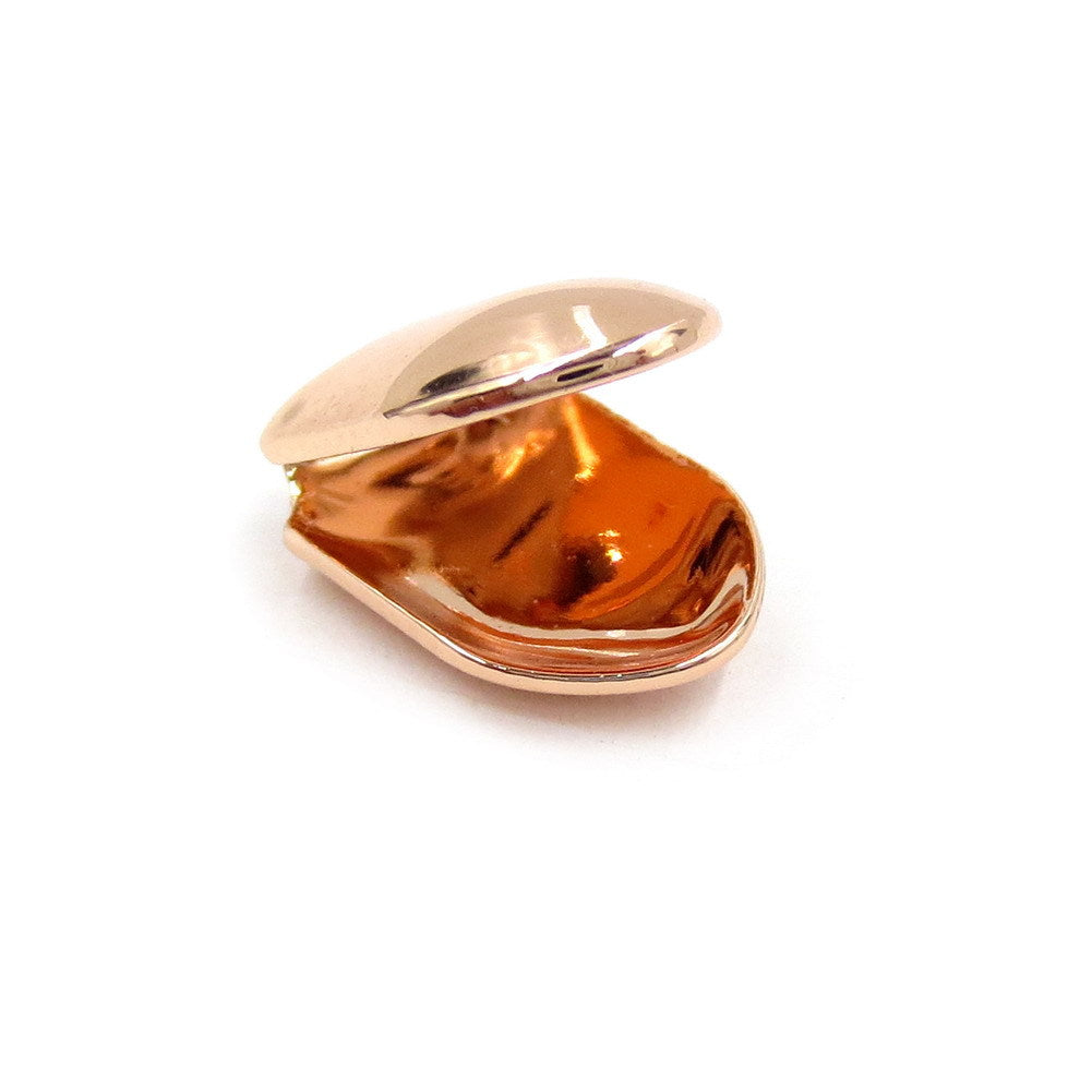 Rose-gold-tone single tooth grill showing the curved inside and open back