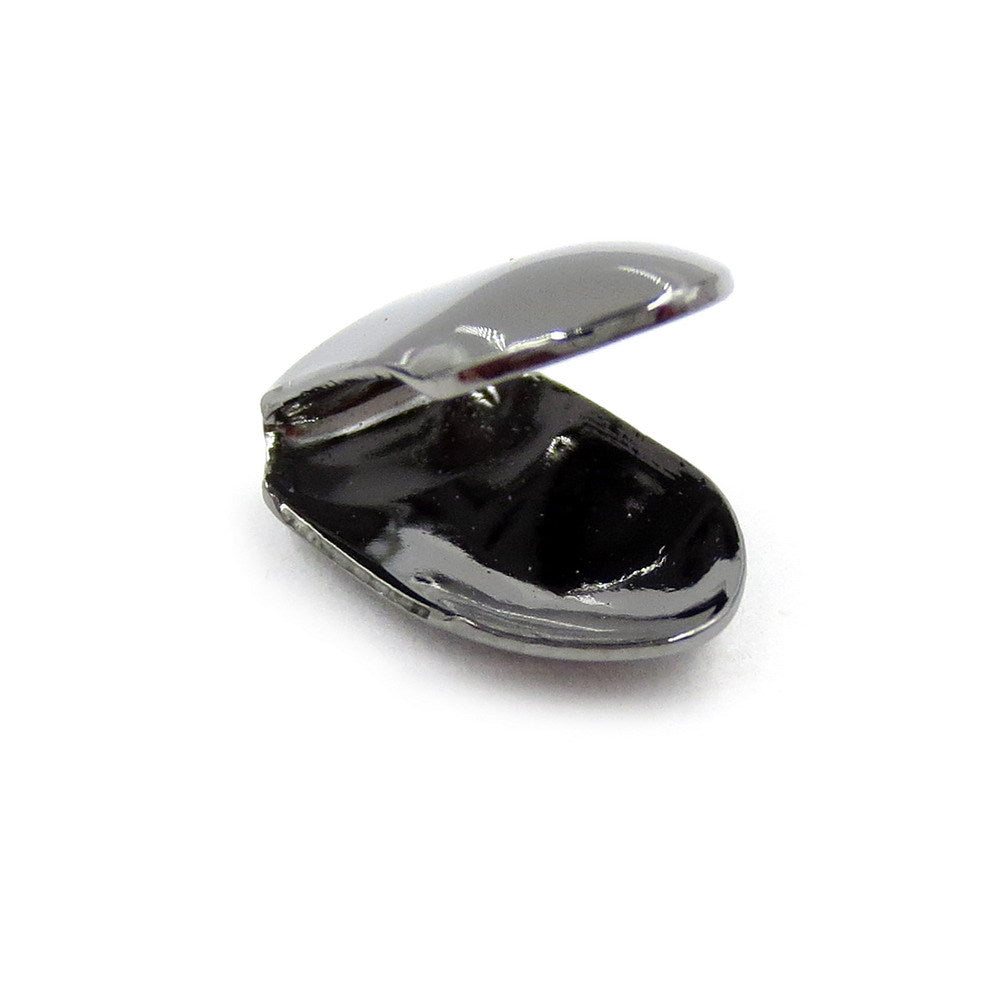 Gunmetal-tone single tooth grill showing the curved inside and open back