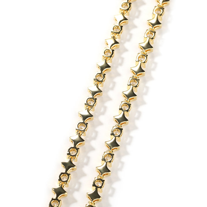 Back of a gold-tone star-link chain showing open settings