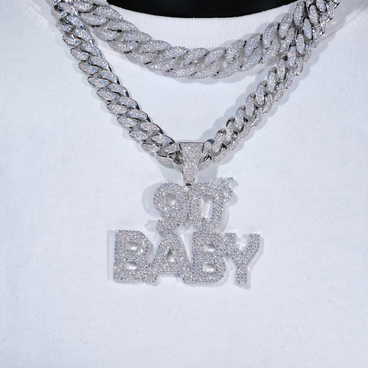 Silver-tone 90's BABY pendant hanging from a Cuban link chain on a white display