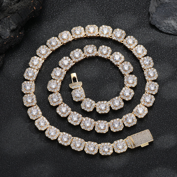 Gold-tone halo-link tennis necklace coiled on a dark surface