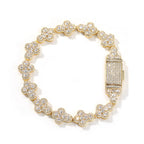 Gold cross shape bracelet with Cubic Zirconia stones on white background