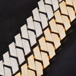 Close-up of silver-tone and gold-tone stone-set Cuban links on black