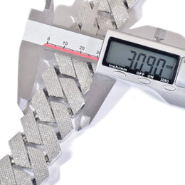 Digital caliper measuring the width of silver-tone stone-set Cuban links