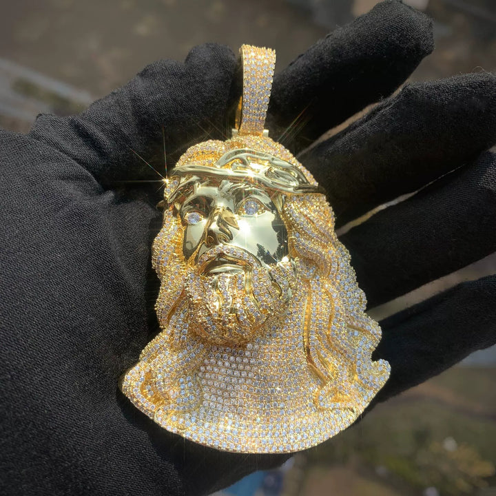 Gold-tone Jesus portrait pendant showing the polished face and stone-set beard