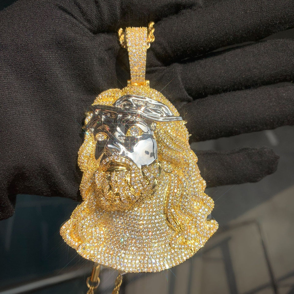 Gold-tone Jesus portrait pendant with a stone-set beard and bail
