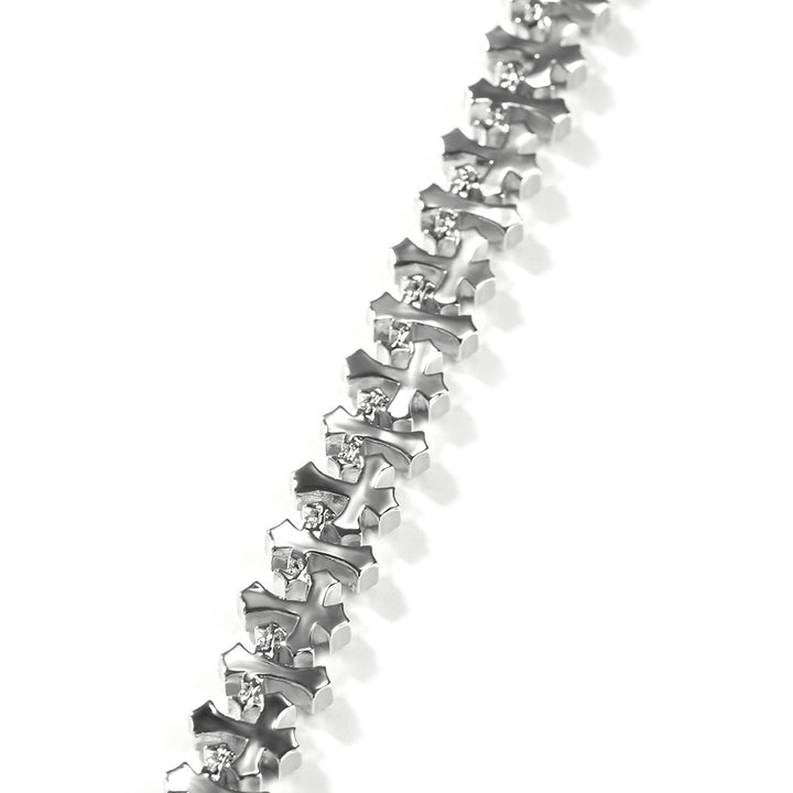 Close-up of silver-tone stone-set cross links