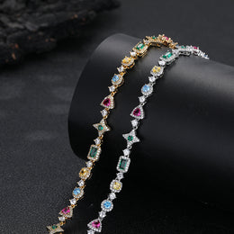 Silver and gold-tone multicolor geometric jewelry on a display