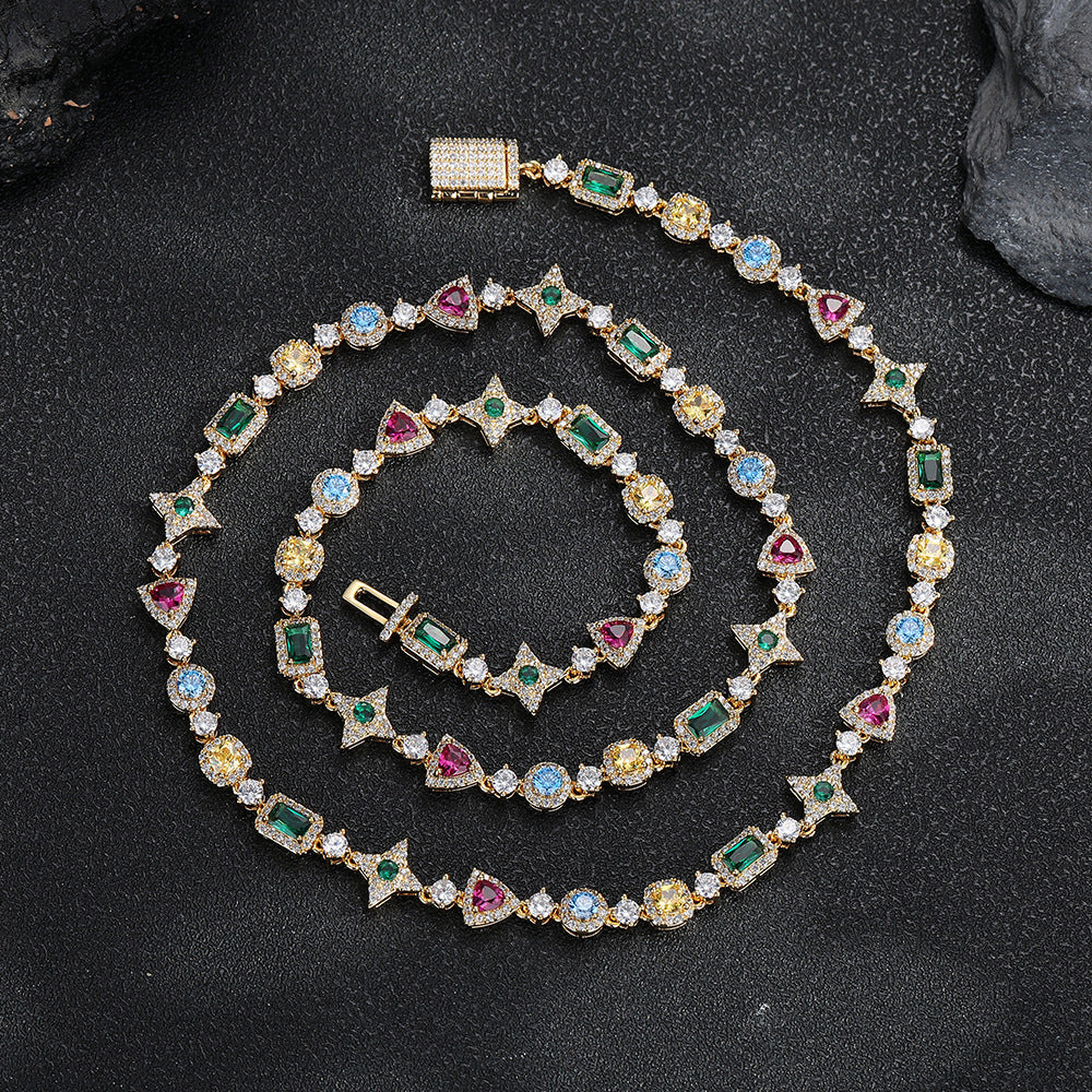 Gold-tone multicolor geometric necklace laid on a dark surface