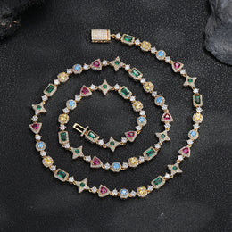 Gold-tone multicolor geometric necklace laid on a dark surface