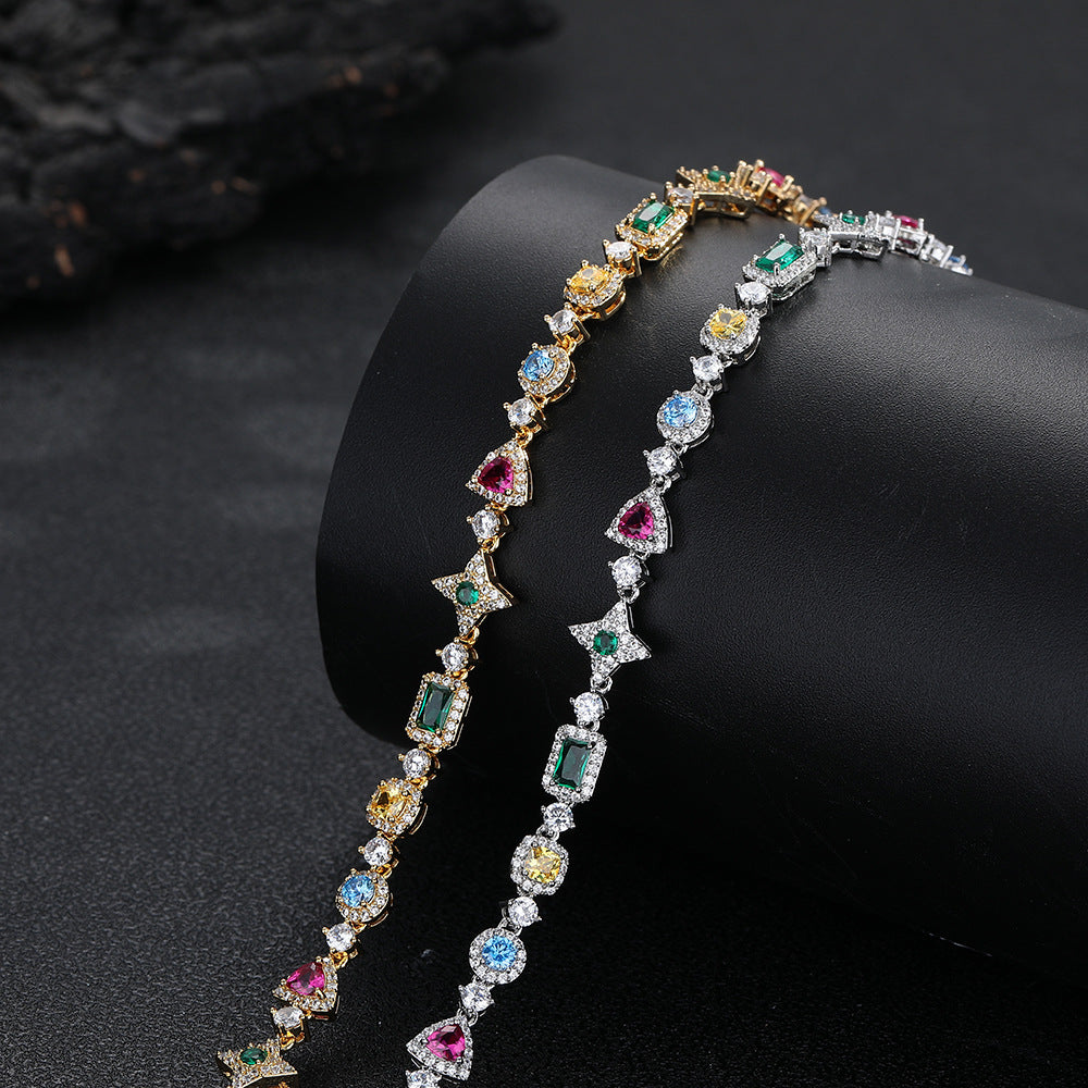Silver and gold-tone multicolor geometric jewelry on a display