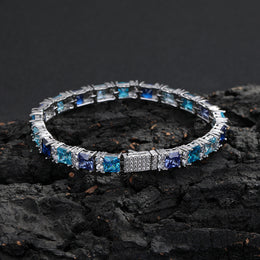 Multicolor square-cut tennis bracelet displayed on dark rock