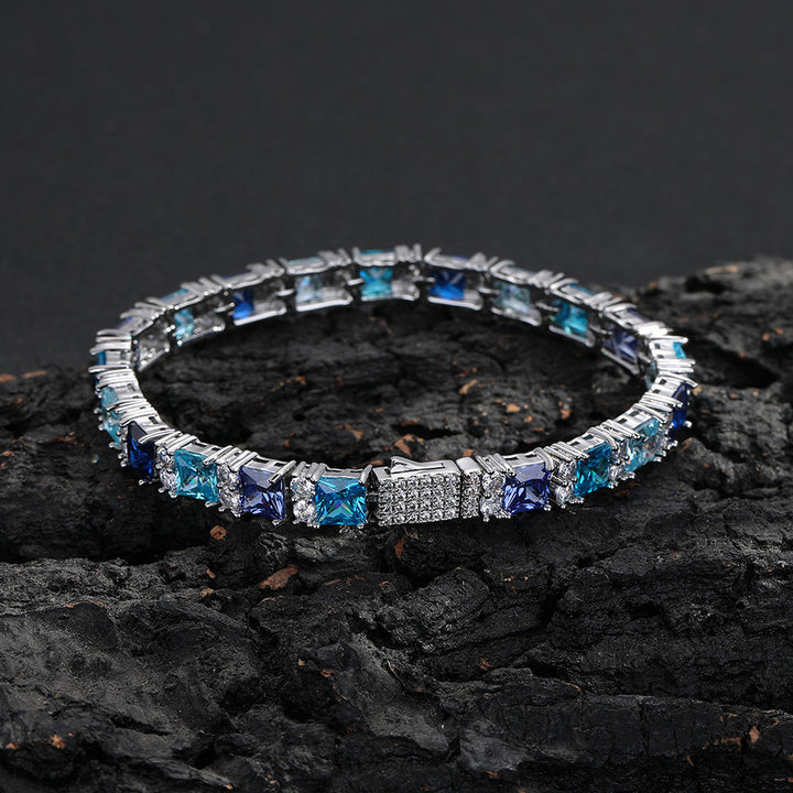 Multicolor square-cut tennis bracelet displayed on dark rock