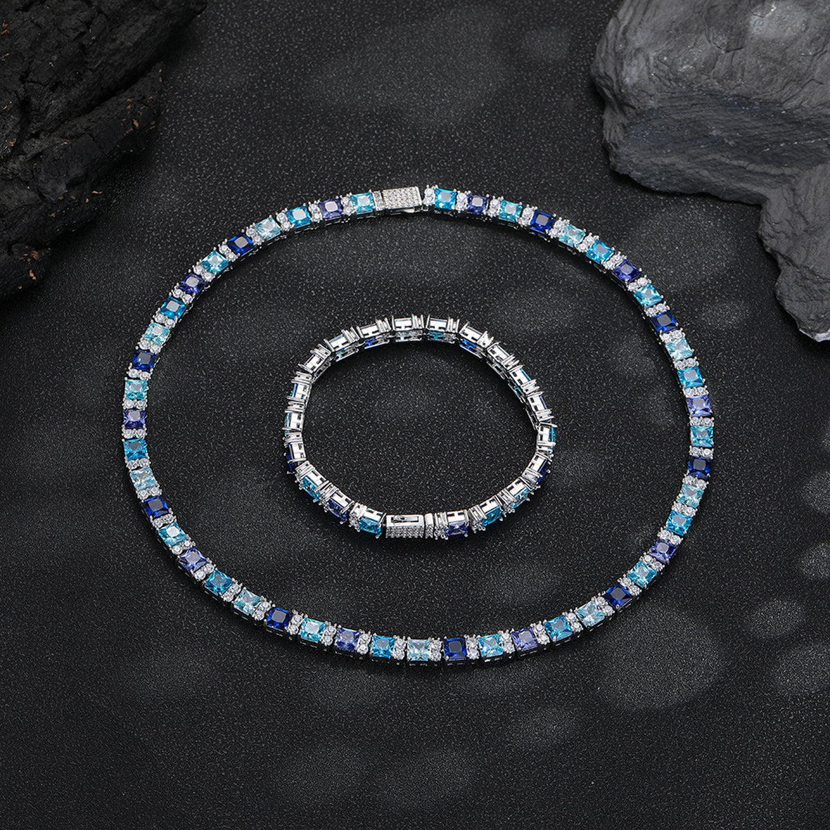 Multicolor tennis necklace and matching bracelet arranged on black