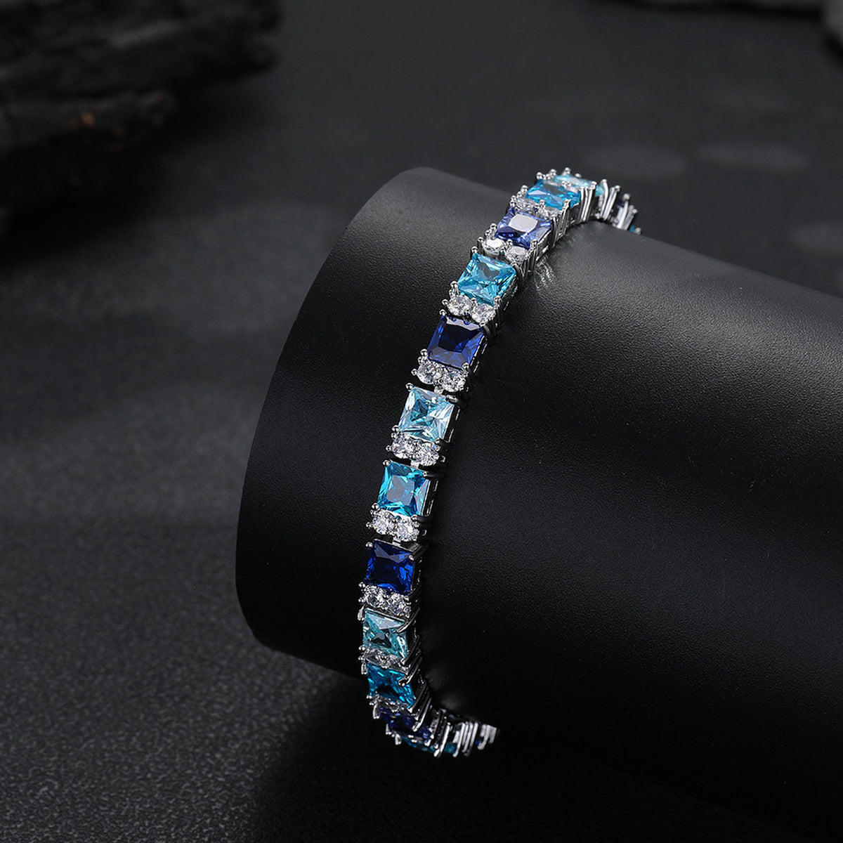 Multicolor tennis bracelet on a black display cuff