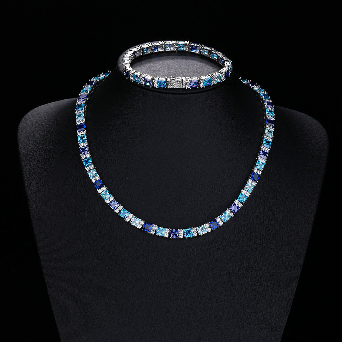 Multicolor tennis necklace and matching bracelet on display busts