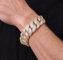 Gold iced Bubble Cuban bracelet worn on a muscular Western model
