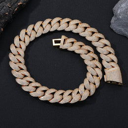 Gold iced Bubble Cuban link necklace arranged on black