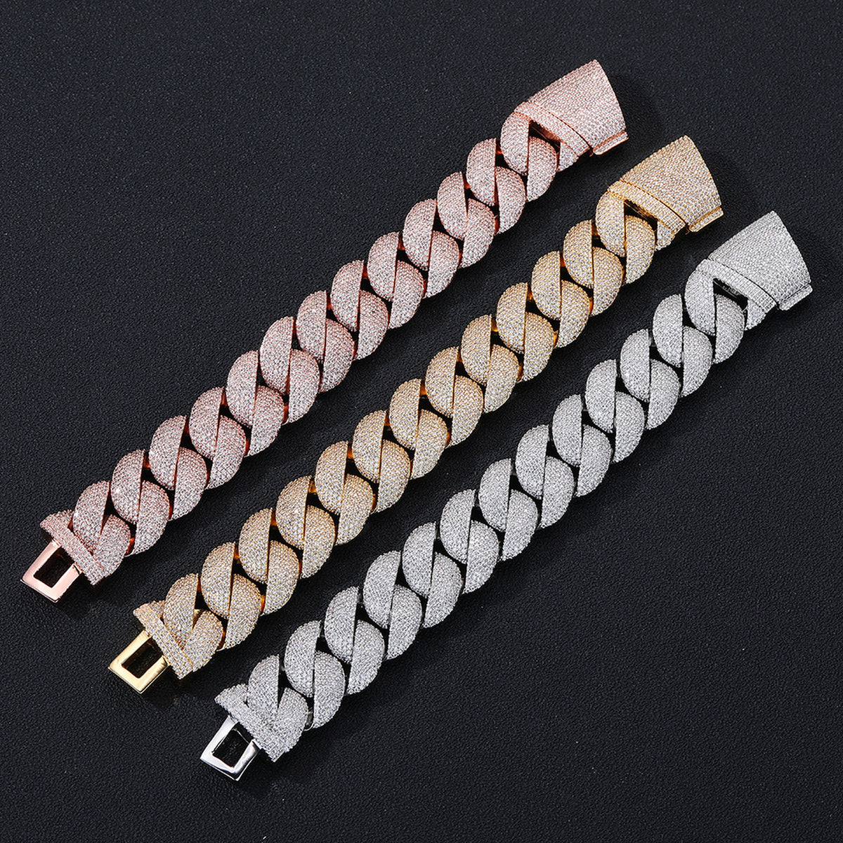 Three iced Bubble Cuban necklace finishes laid flat on black