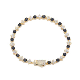Gold-tone black stone star tennis bracelet on white