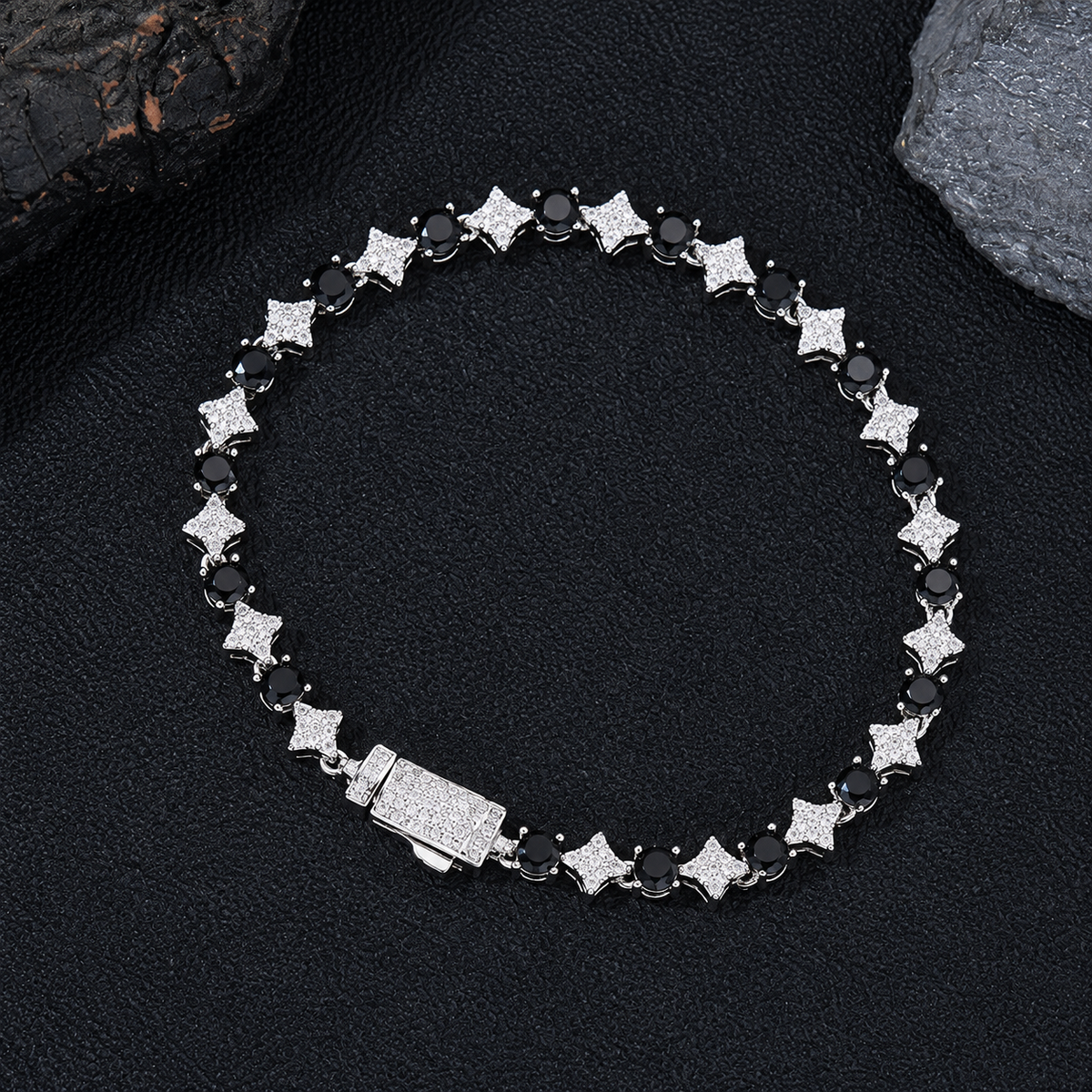 Silver-tone black round stone and clear star link bracelet with a box clasp on black fabric