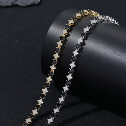 Silver and Gold bracelet links with black round stones and clear pavé stars on a black roll