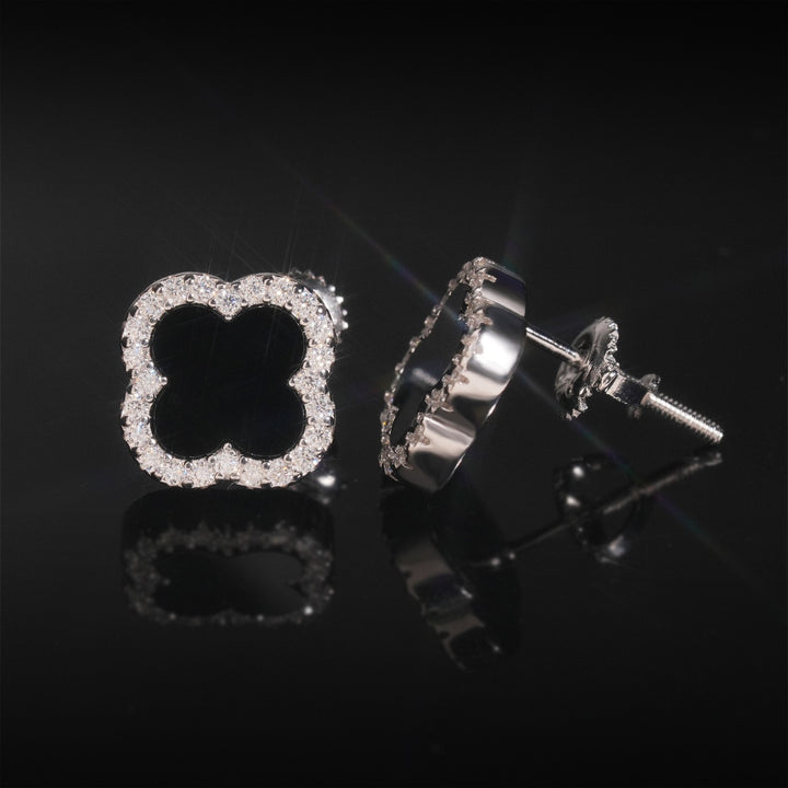 Black clover stud earrings showing the front and side setting