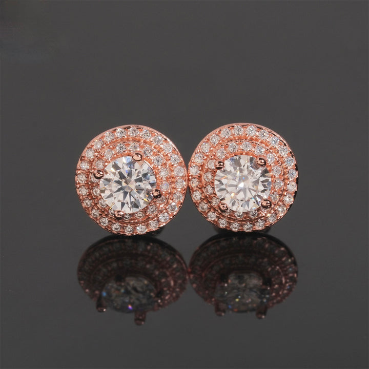 Pair of pink-tone round halo stud earrings with clear stones