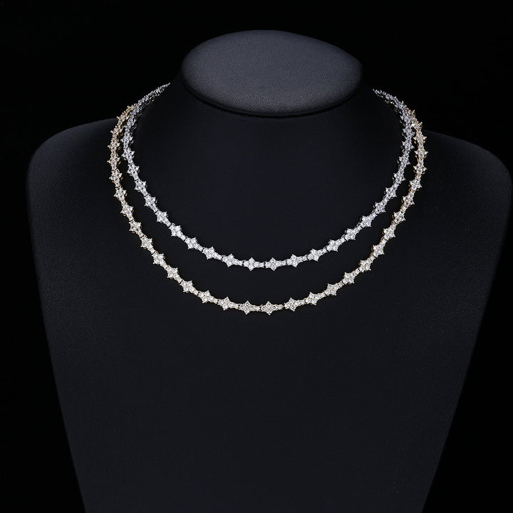 Two star-link necklaces layered on a black display bust