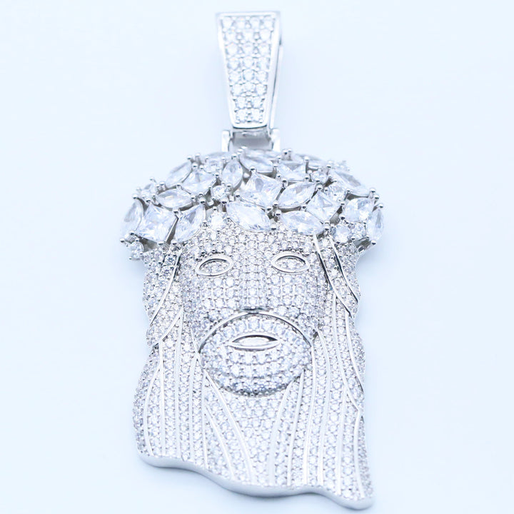 A silver-tone Jesus head pendant encrusted with clear cubic zirconia stones, shown against a plain white background.