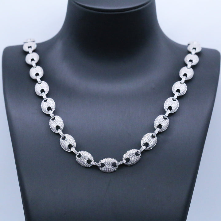 Silver-tone stone-set oval-link necklace on a black display bust