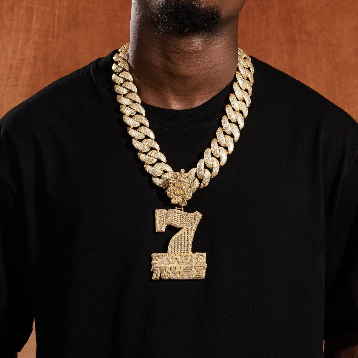 Gold iced 7 Figure Twizz pendant displayed with Cuban links