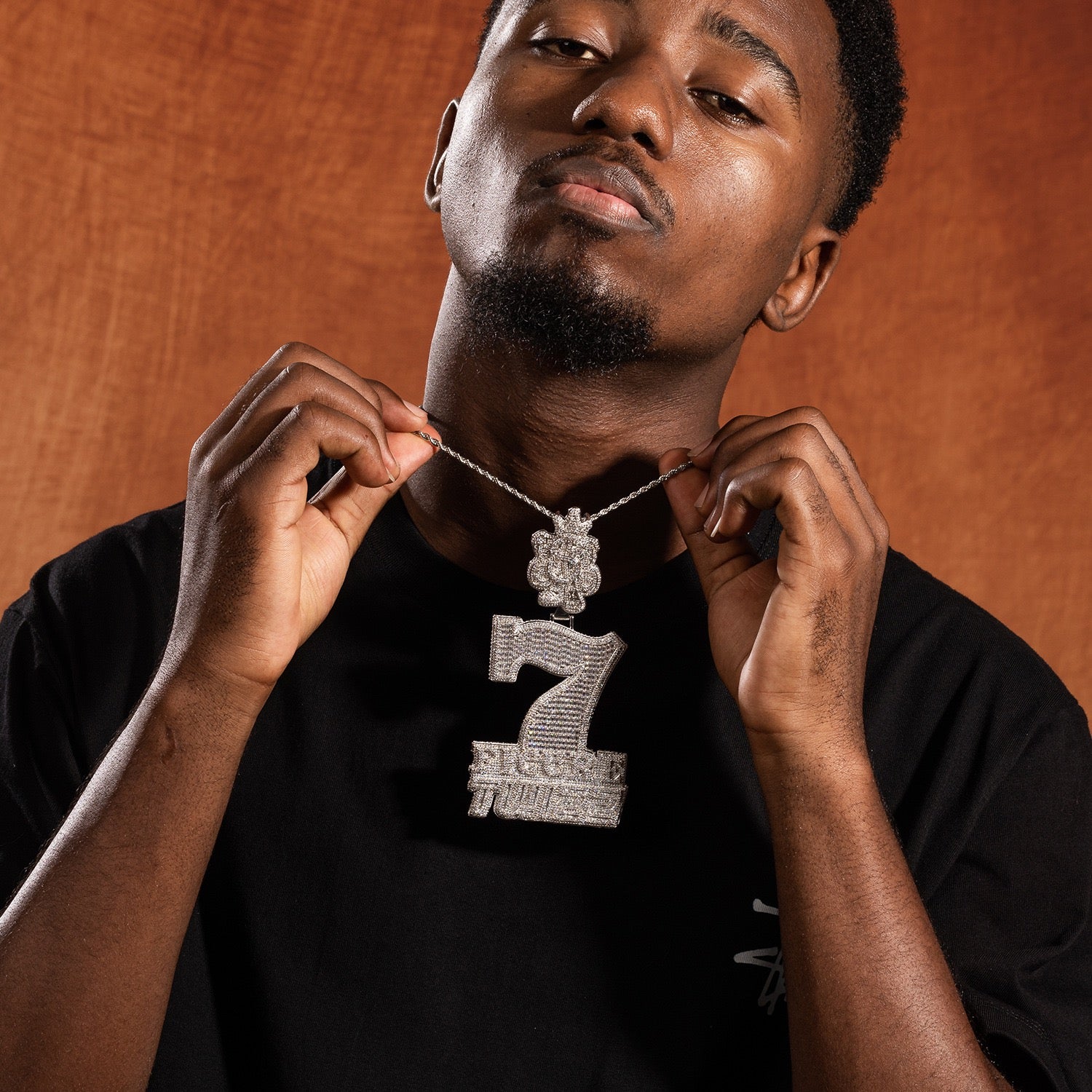 Model displaying silver iced 7 Figure Twizz pendant