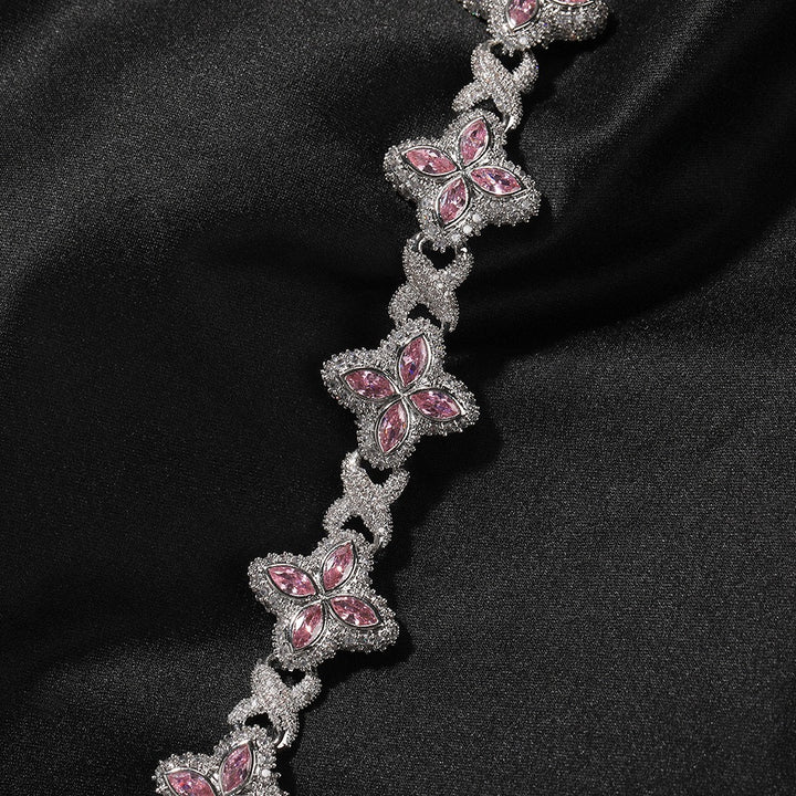 Silver-tone butterfly-link necklace with pink accent stones on dark fabric