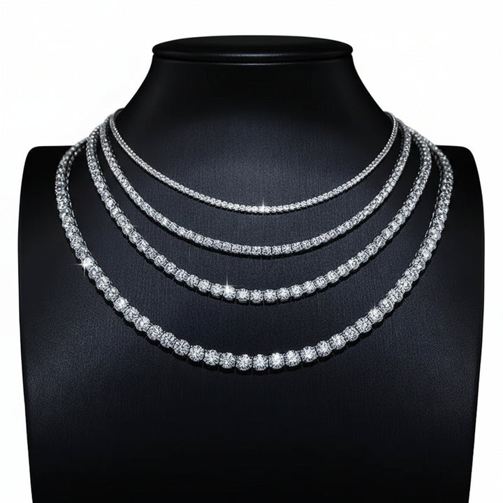 Silver-tone tennis necklaces in several widths on a black display bust
