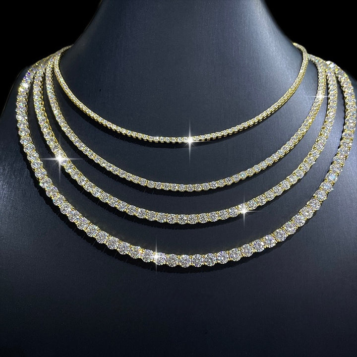 Gold-tone tennis necklaces in several widths on a black display bust