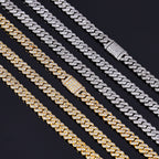 Gold and silver iced out Cuban link chains with diamond clasps on black background - Miles Jewellery