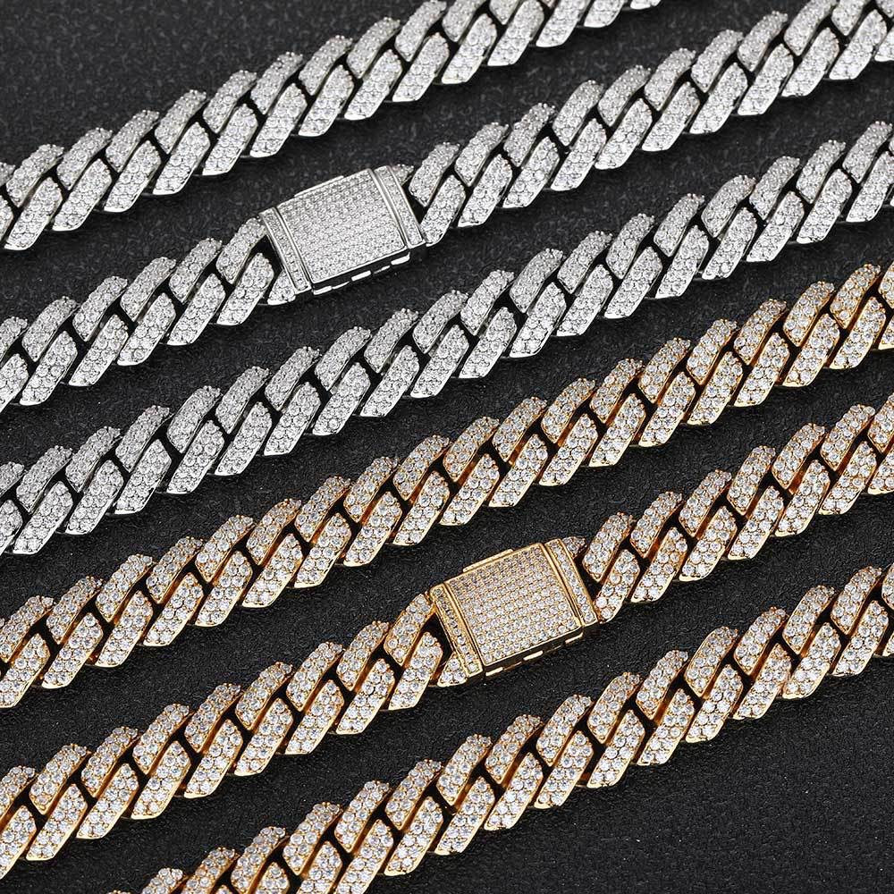 Iced out Cuban link chains in silver and gold with diamond detailing on black background - Miles Jewellery