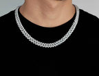 Iced out Cuban link chain necklace on man wearing black shirt - Miles Jewellery