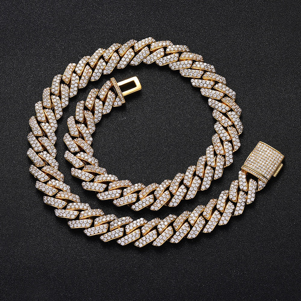 Gold Cuban link chain with pavé stones on black background - Miles Jewellery