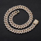 Gold Cuban link chain with pavé stones on black background - Miles Jewellery