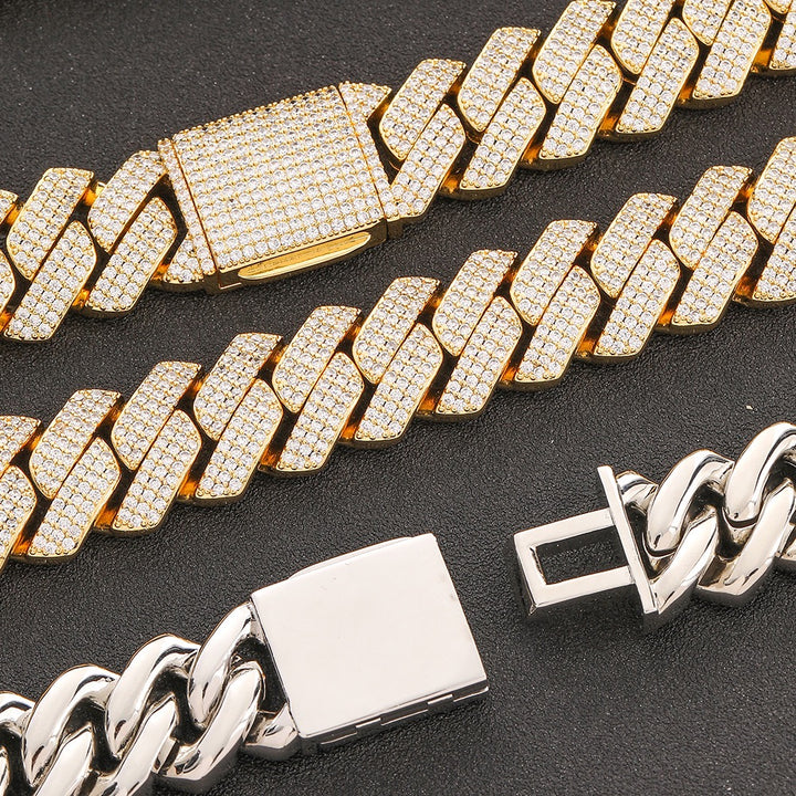 Stone-set gold-tone Cuban links beside a polished chain back and clasp