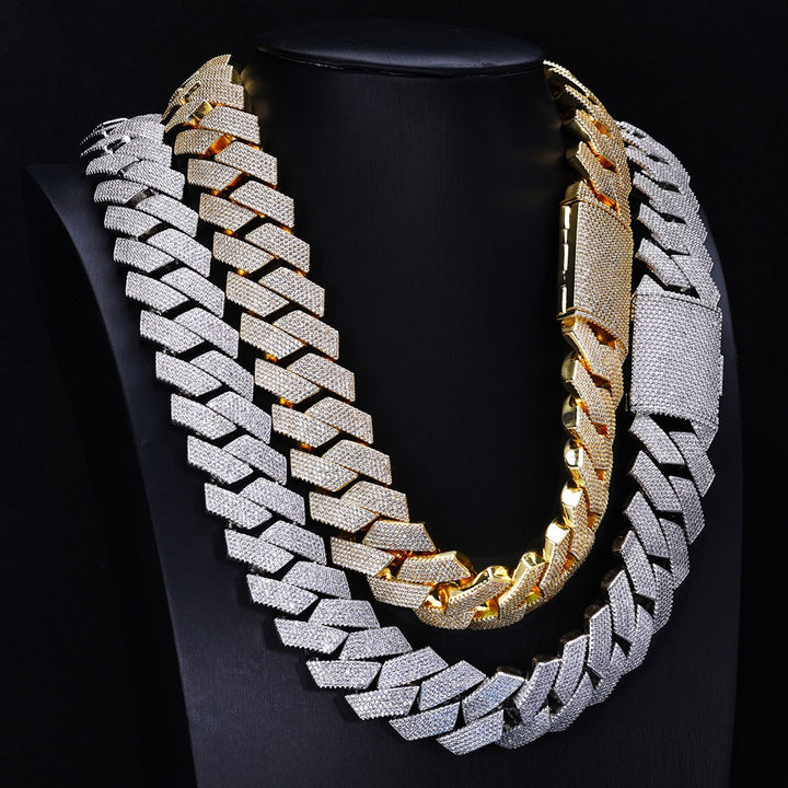 Gold-tone and silver-tone wide Cuban link necklaces on a black display bust