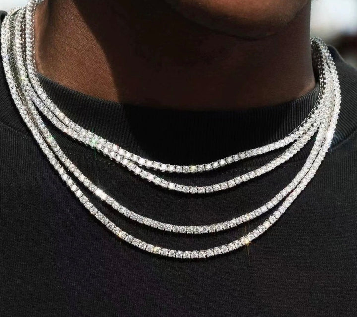 Tennis necklaces in several widths layered over a dark shirt