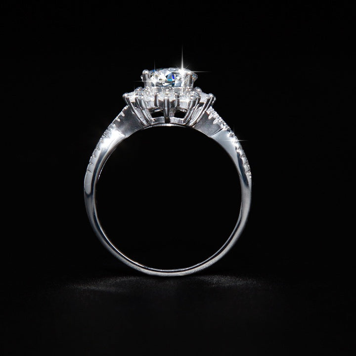 Side profile of a silver-tone halo ring showing the raised setting