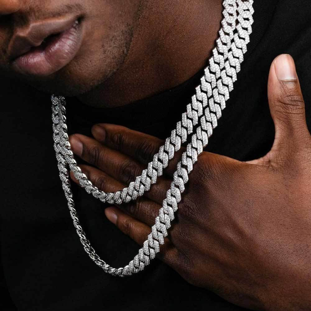 Man wearing two iced out hip hop style Cuban link chains on black shirt - Miles Jewellery