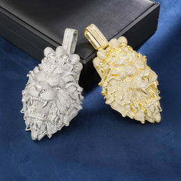 Gold and silver lion head pendants on a blue background