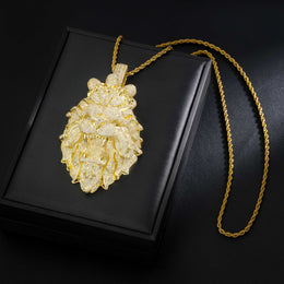 Gold lion pendant necklace on a black box